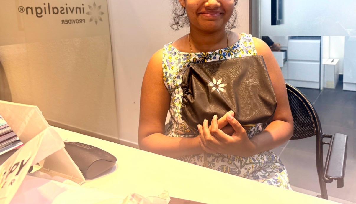 Patient with an Invisalign aligner kit at Studio Dental